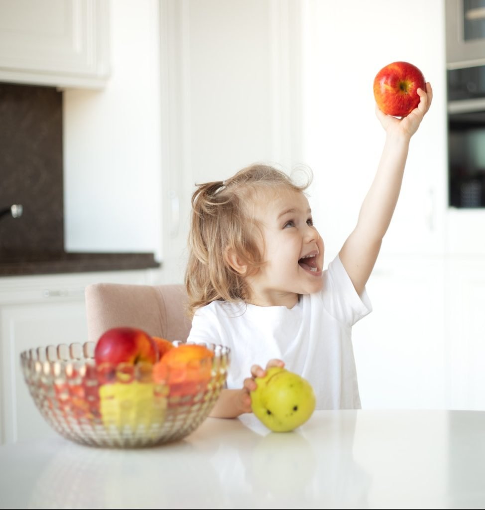 emotion child girl eating apple. Enjoy eating moment. Healthy food and kid