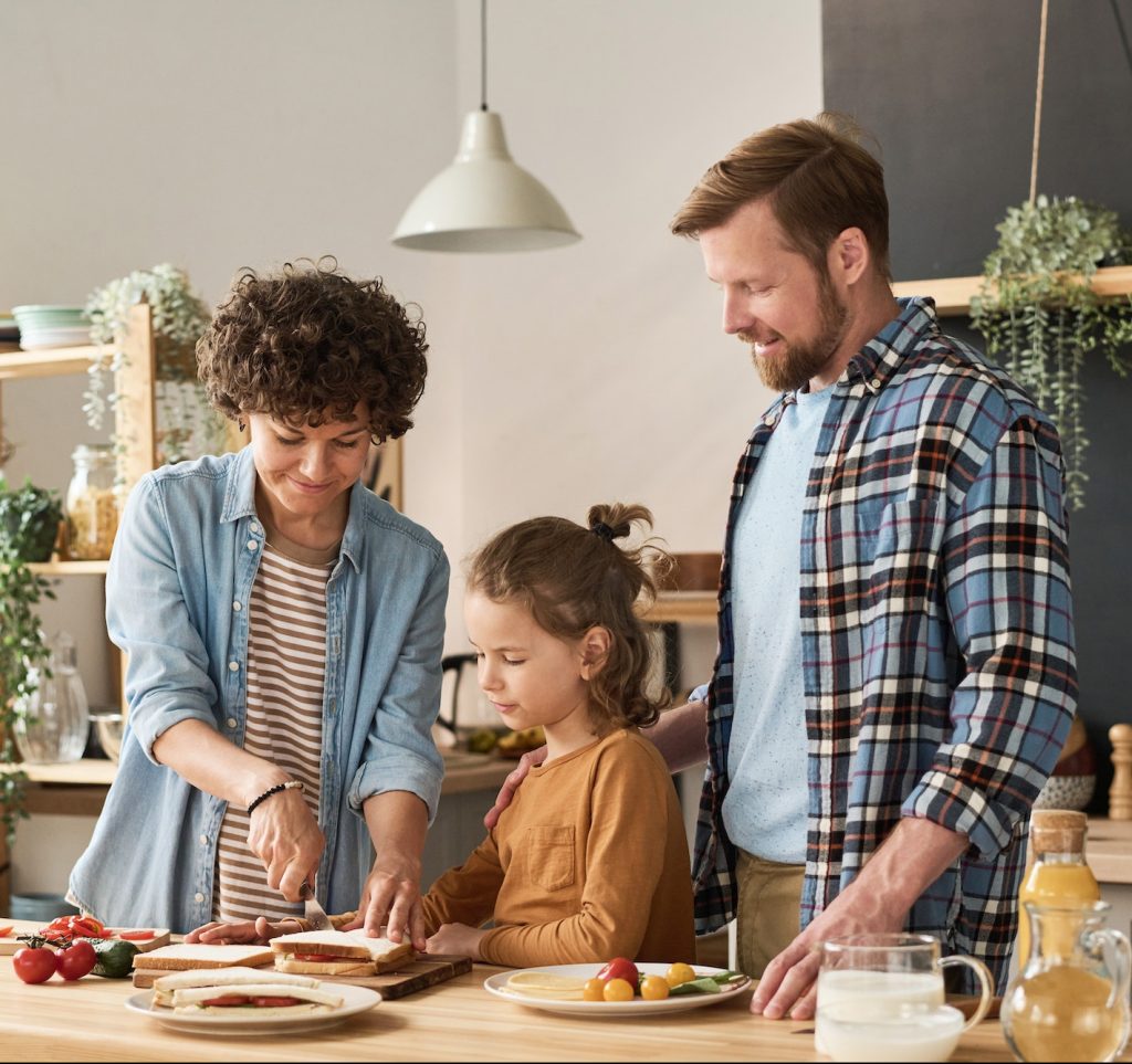 Family cooking sandwiches together